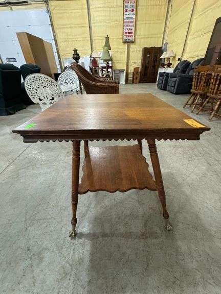 Antique Victorian tiger oak parlor table with turned legs and brass claw feet. Very good condition