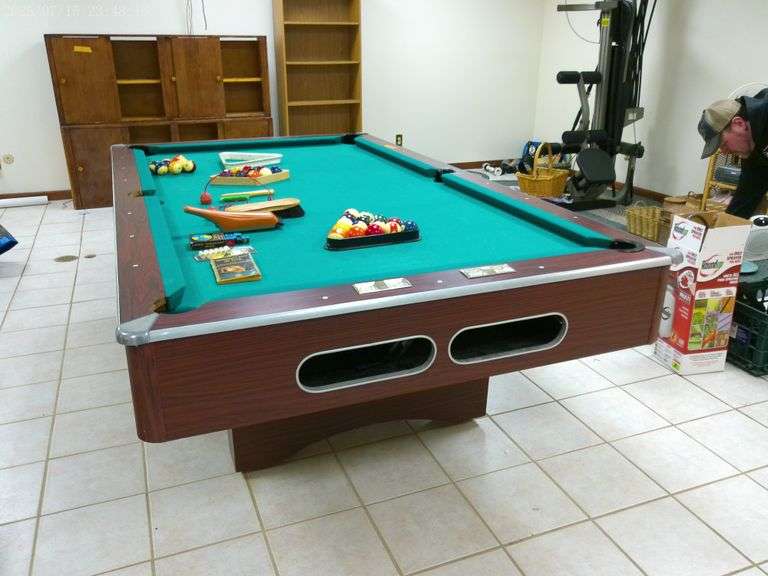 Pool table, slate top three piece, includes balls, sticks, accessories. 3 of the pockets are damaged