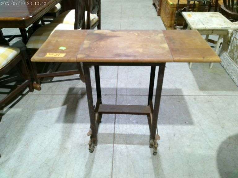 303 - 24 Old typewriter stand with leaves. With leaves up 36" wide. On casters