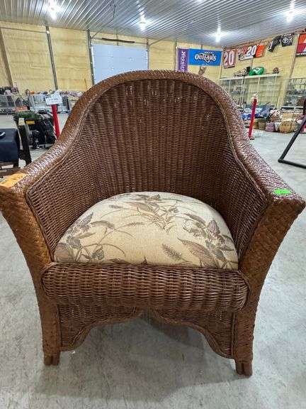 Wicker accent chair with upholstered seat in greenery/floral pattern. Very nice condition