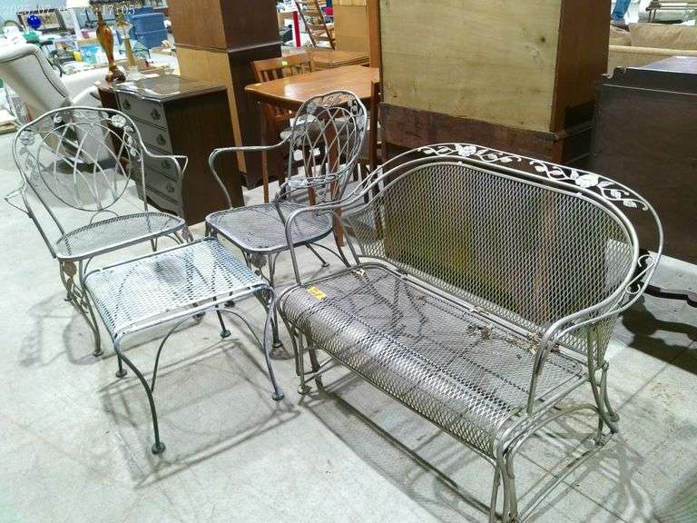 352 Four pieces of metal outdoor furniture. Glider, side table, two chairs.