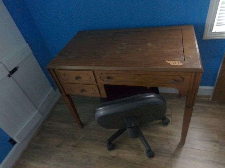 Sewing Machine Cabinet (no sewing machine). It has been used as a desk. 2 drawers. Rolling desk chai