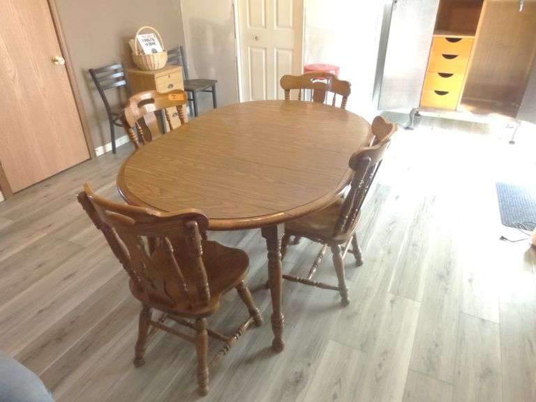 Drop Leaf Kitchen Table with 4 Chairs. Comes with 2 leaves. Minor surface stain on top. Small chip o