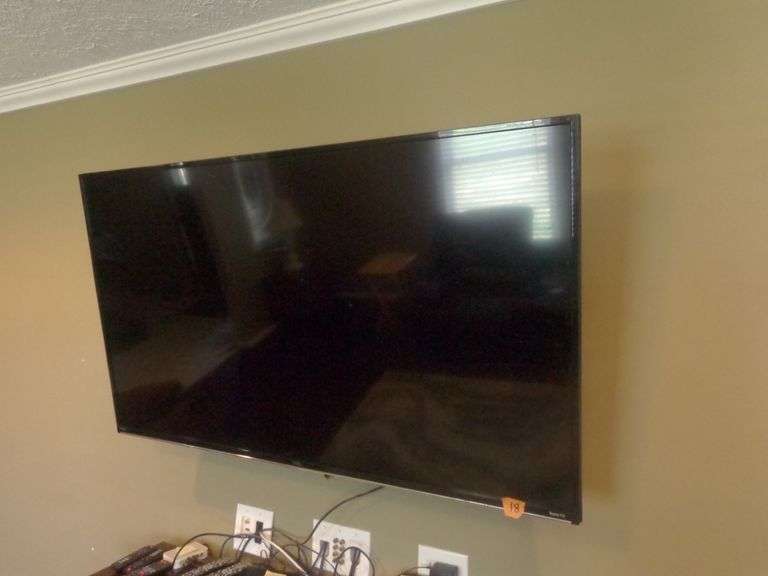 55" Roku TV with Remote. TV is untested. TV is bolted to the wall on a swivel bracket. Buyer must re