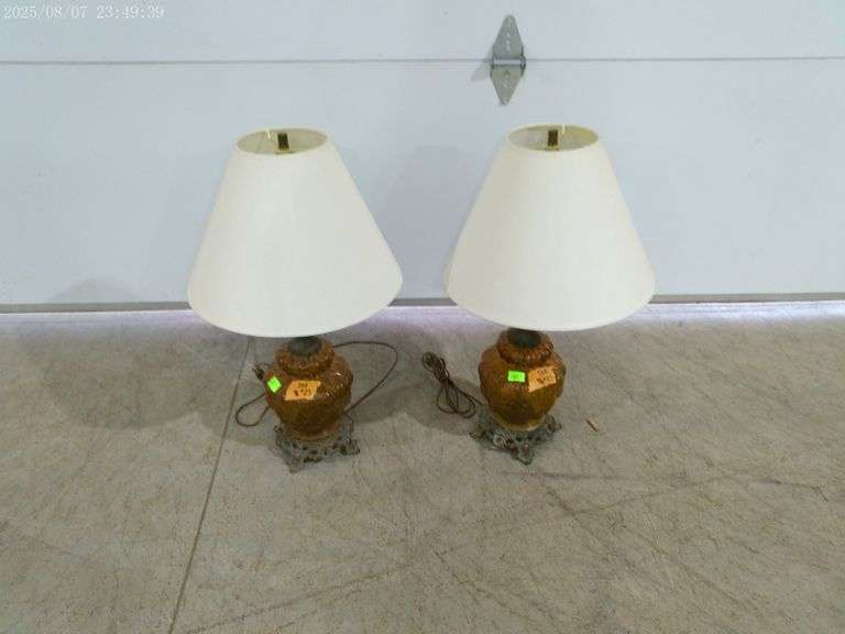 502- Pair of lamps with metal and amber glass base. White clean shades, lamps are 25" tall