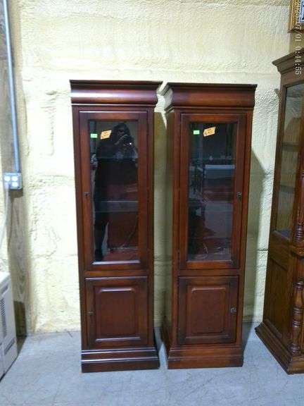 504- Pair of narrow wooden and glass lighted curio or display cabinets. 2 glass shelves, lower stora