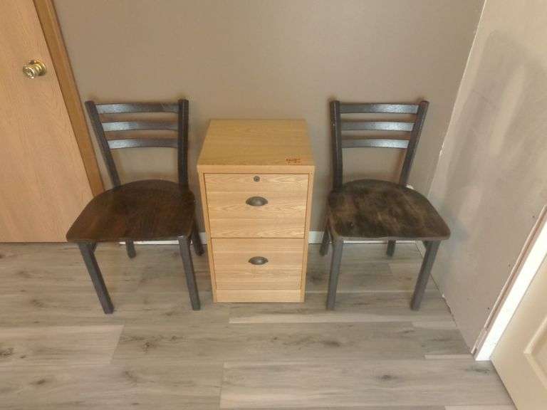 2 Drawer File Cabinet and 2 Wooden chairs. See pictures for condition. Located in the kitchen.
