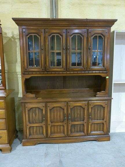 563 - Wooden hutch with glass doors above, one wooden shelf and lower storage. Some damage on top