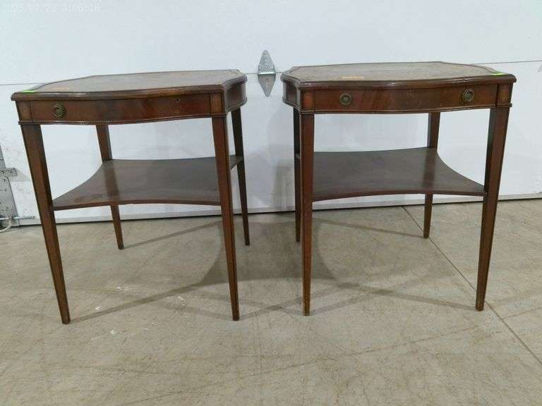 562 - Pair of leather top end tables with drawers, lower shelf. Tops are 23" x 23", 26" tall. Shows 