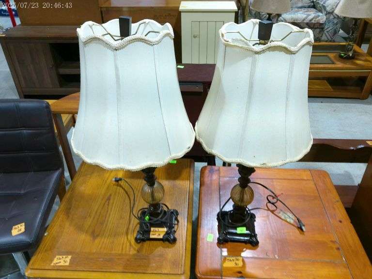 563 - Pair of lamps metal and glass base, one shade has a tear. 32" tall