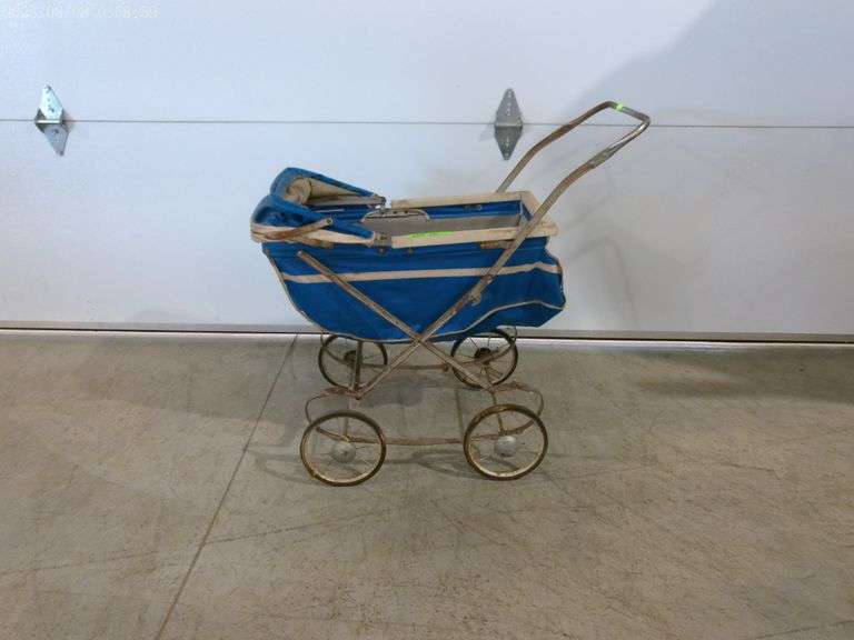 603 – vintage baby doll carriage with blue fabric and white frame. Condition is rusty