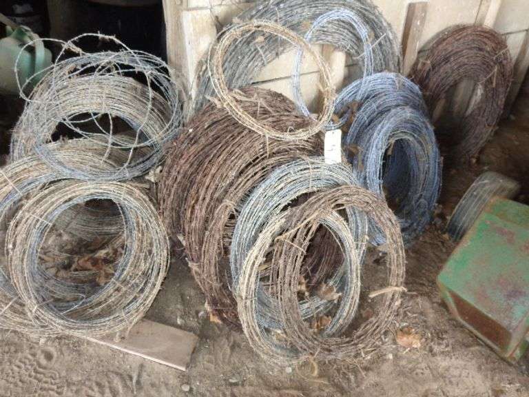 numerous rolls of used barbed wire