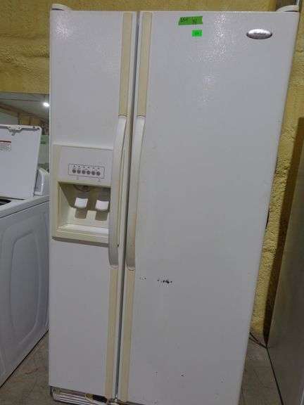 654- Whirlpool side by side refrigerator and freezer, ice and water on door, tested and working