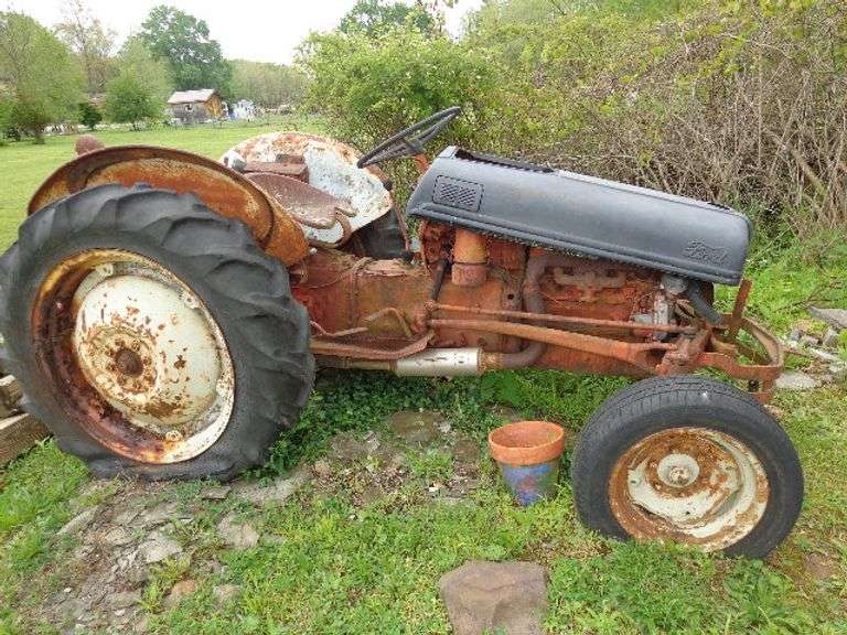 Ford 8N Parts Tractor. Not running. Wheels are rusting. Condition of tractor completely unknown. See