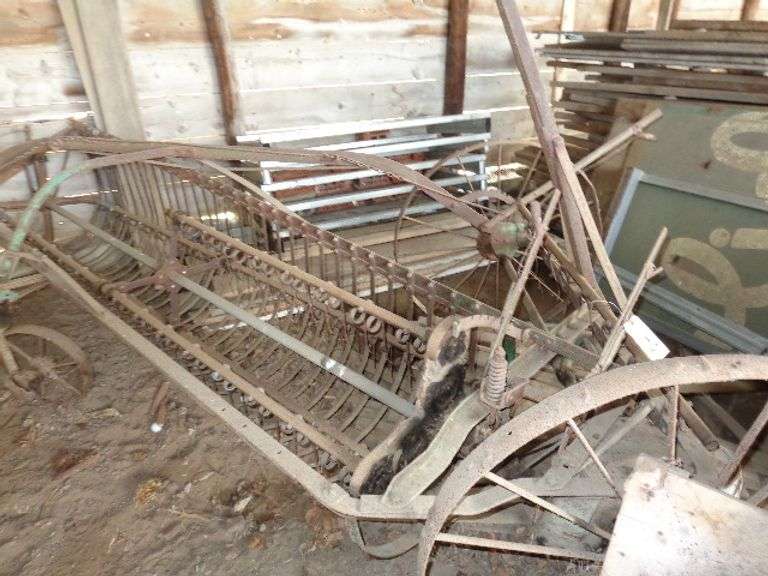 2 partial John Deere iron wheel hay rakes
