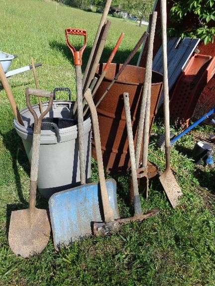 Misc long hand tools, burn barrel, trash cans. See pictures for details. Located by building.