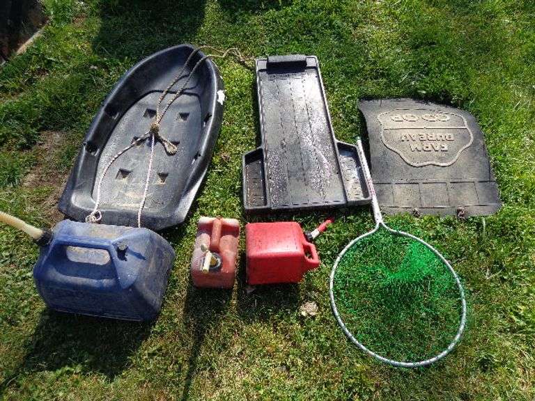 2 small gas cans, mechanic creeper, child's sled, kerosene can, fishing net, and mud flap. Located b