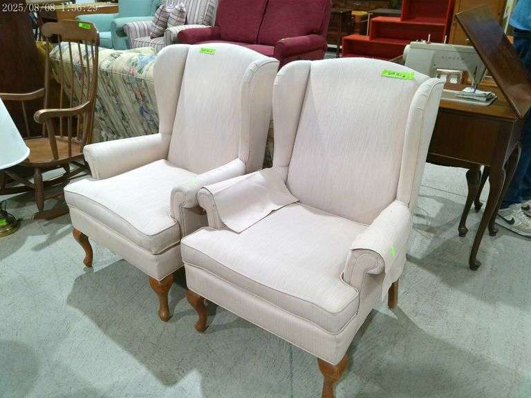 609- pair of off white upholstered wing back chairs, shows considerable wear