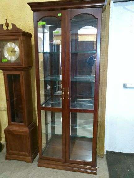 603 – display case with four glass shelves, mirror in back, lighted. 6 feet tall, 28 inches wide, 12