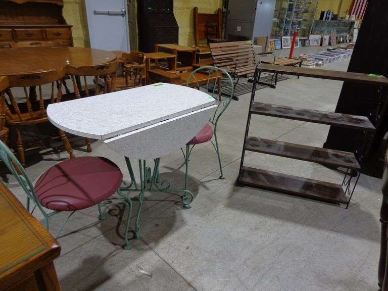 655- Drop leaf bistro table, formica top, wrought iron chairs and table legs, 3 feet around with lea