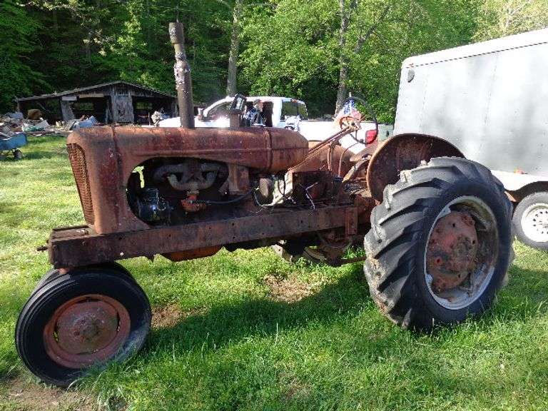 Allis-Chalmers WD45 Tractor. Not running. Flat tire, No spark plugs in it.