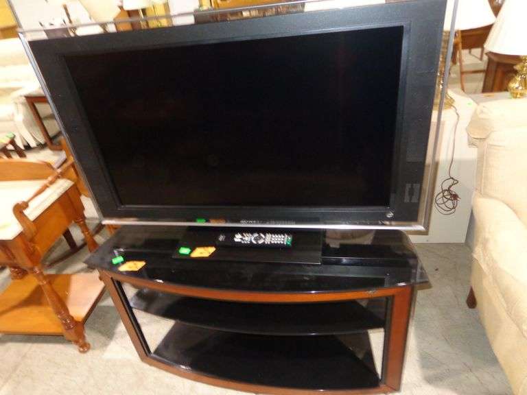 752 - 40" Bravia TV with remote and black/brown stand. TV comes on