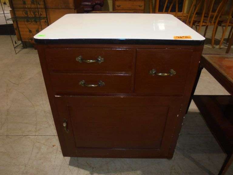 Cabinet with porcelain top. 3 drawers and 1 door. 27" wide x 22" deep x 32" tall. See pictures.
