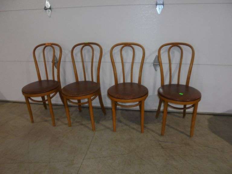 Four bentwood chairs with leather like padded seats. 1 has small tear. See pictures.