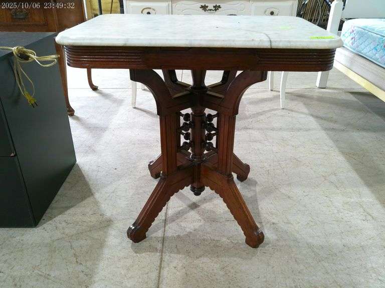 810- Ornate wooden side table with marble top, top has crack, 30" by 20"