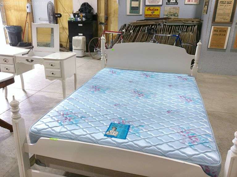 810- Full sized white bed with ortho-bracer mattress and box spring. White wooden vanity, in rough c