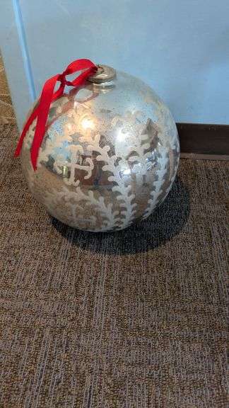 Large Decorative Ornament with Silver Reflective Surface and Red Ribbon