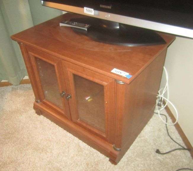Laminate TV stand w/ glass doors Mark Van Hook, Auctioneer