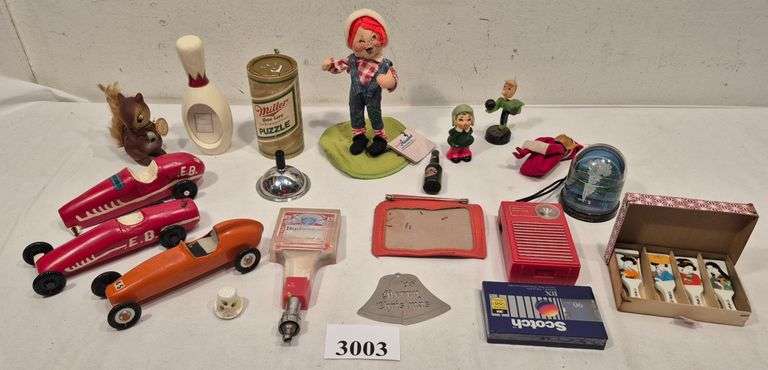 Pinewood Derby cars, figurines, Miller High Life puzzle, transistor radio, plastic snow globe, Budwe