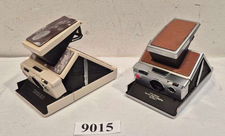 Two Polaroid SX70 folding instant cameras