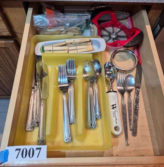Contents of two drawers and a cabinet including flatware, kitchen utensils, food containers, pitcher