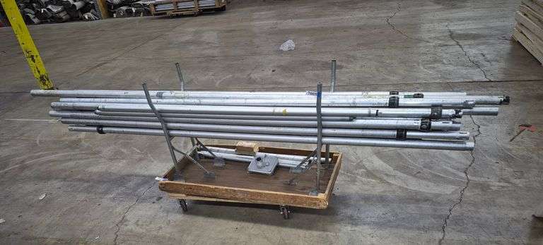 Metal (aluminum?) tubing, small wood folding table, four wheel moving dolly
