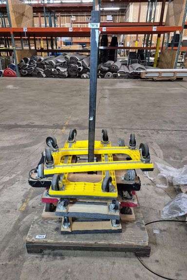 Seven four-wheel mover's dollies, rack