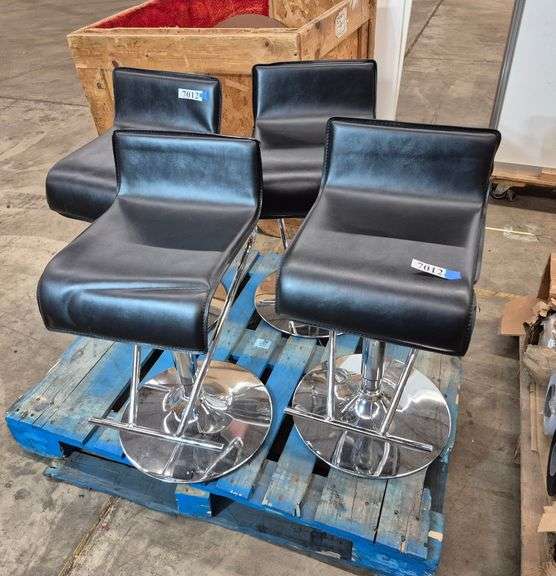 Four black and chrome adjustable height stools