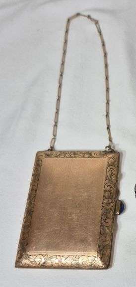Antique compact with chain marked "solid gold shell"