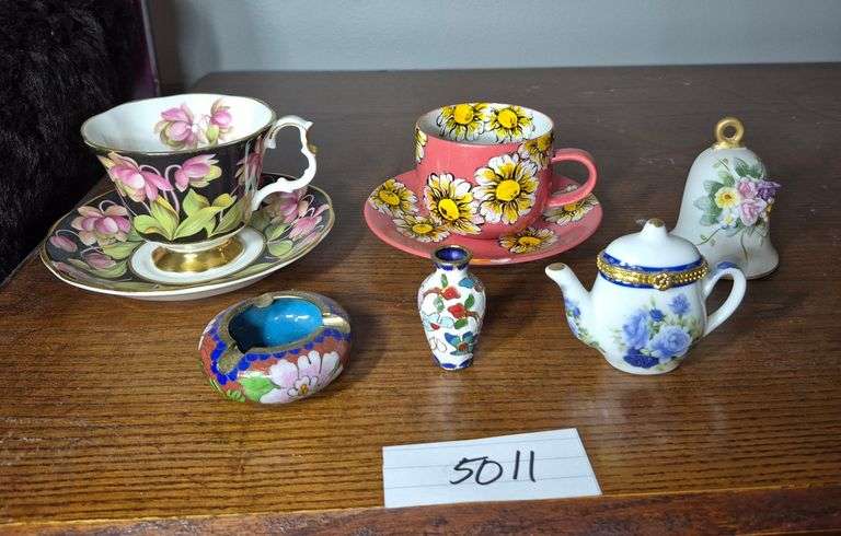 Cups and saucers, teapot trinket box, bell, miniature cloisonné ashtray and vase
