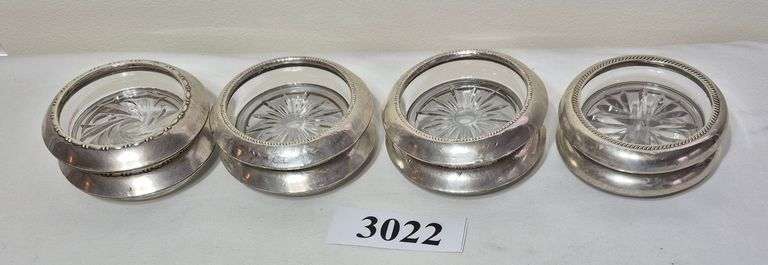 Eight sterling silver rim coasters / ashtrays of four different patterns