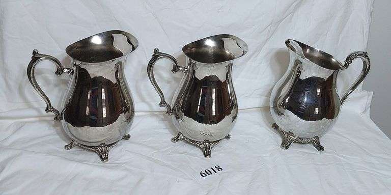 Three silverplate pitchers