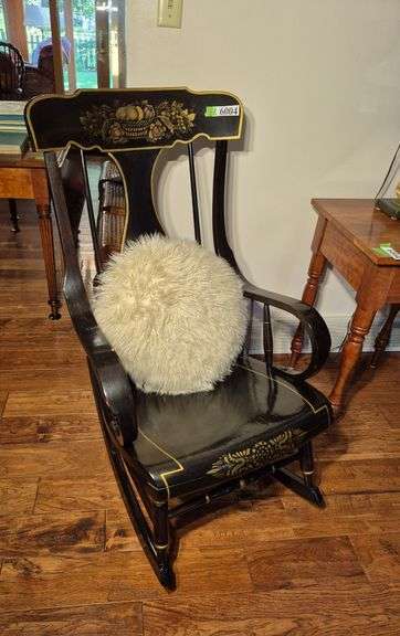 Black rocking armchair with gold stenciled decoration