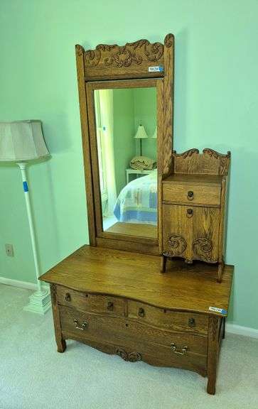 Antique bi-level gentleman's dresser with a hatbox and a swivel mirror