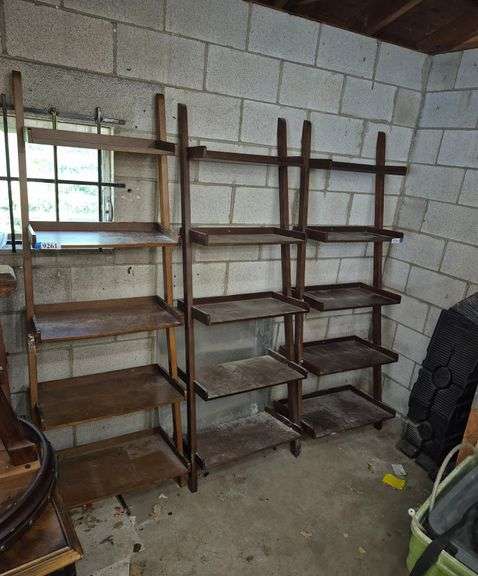 Three leaning book / display shelves