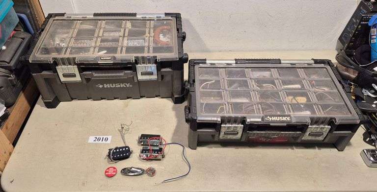 Two Husky organizer tool boxes full of guitar parts including pickups, tuning pegs, bridges, Etc