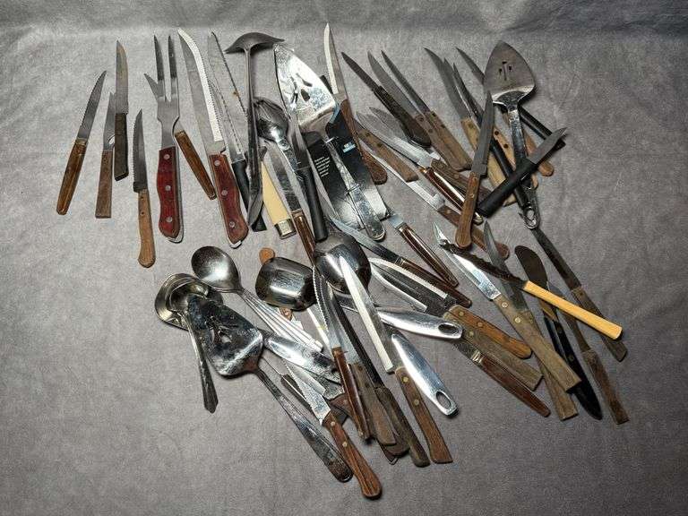 Large assortment of kitchen knives and various kitchen utensils