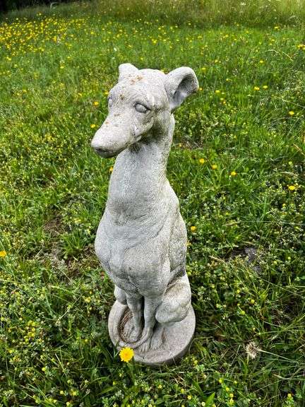 Cement sitting greyhound dog statue