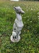 Cement sitting greyhound dog statue