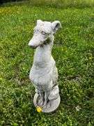 Cement sitting greyhound dog statue